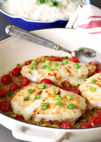 Tomatillo Salsa Verde Chicken Breasts in a Skillet with Cherry Tomatoes