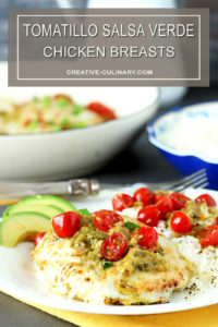 Tomatillo Salsa Verde Chicken Breasts on a White Plate with Avocado and Cherry Tomatoes