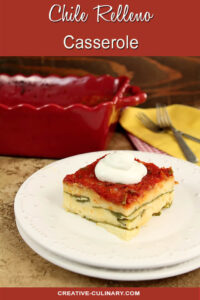 Chile Relleno Casserole Served on a White Plate, Garnished with Sour Cream.