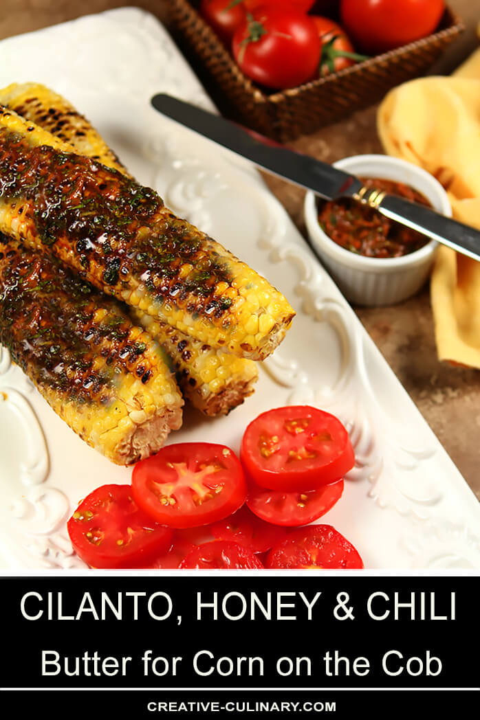 Platter of Cilantro, Honey, and Chile Corn on the Cob Served with a Warm Taco on a White Plate with Tomatoe Slices