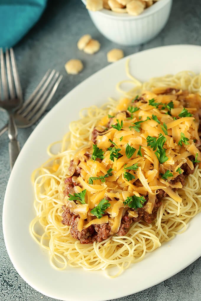 Cincinnati Chili with Cheese from above with a Bowl of Oyster Crackers