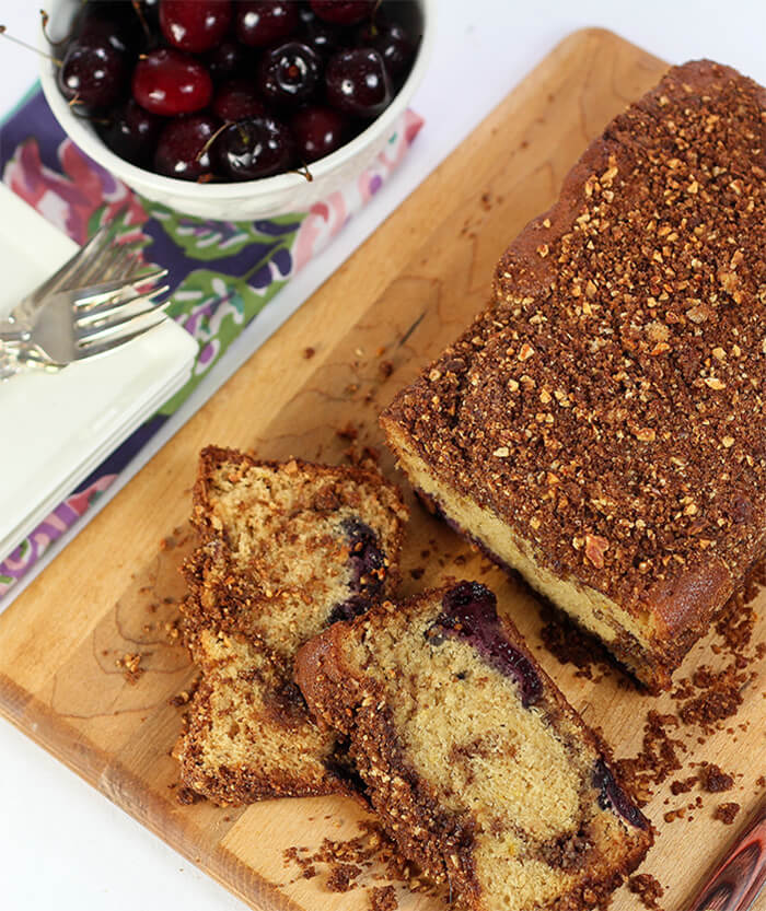 Loaf of Cinnamon Bread with Cherries with Slices on a Bread Board