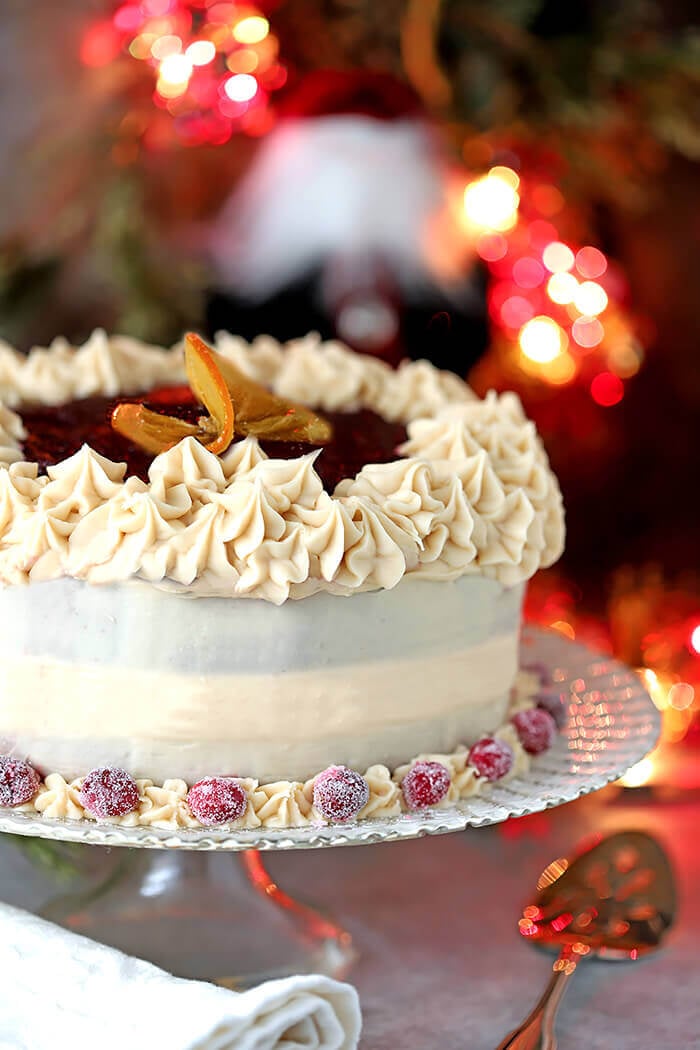 Orange Cake with Buttercream Frosting and Cranberry Glaze on Glass Serving Plate