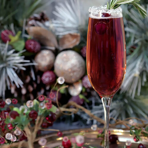 Beautiful Cranberry Pointsetta Cocktail Garnished with Rosemary and Cranberries