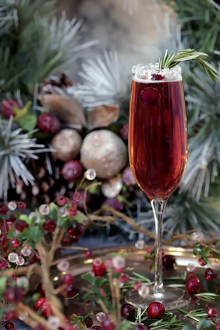 Beautiful Cranberry Pointsetta Cocktail Garnished with Rosemary and Cranberries