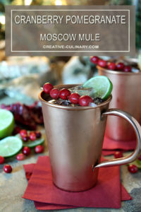 Cranberry Pomegranate Moscow Mule Served in a Copper Mug with Cranberry and Lime Garnish