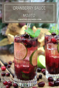 Cranberry Sauce Mojito Cocktails in a Tall Glass Garnished with Cranberries and Mint