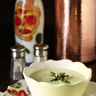 Cream of Roasted Asparagus Soup with Garlic & Parmesan in a Yellow and White Bowl