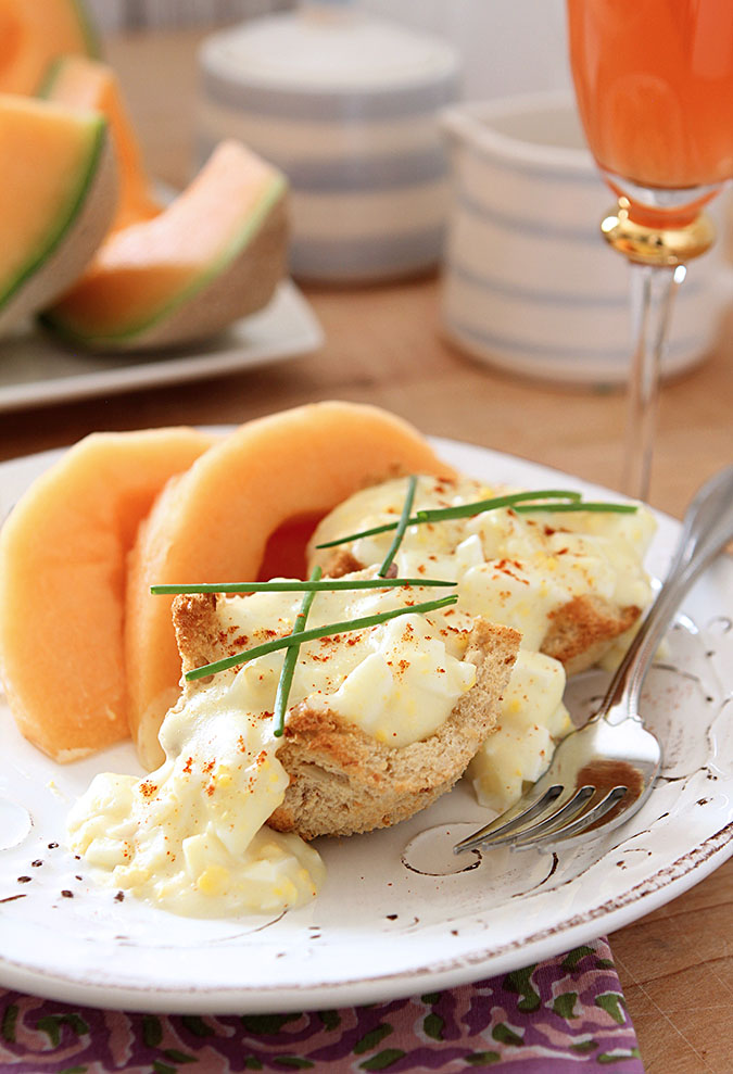 Creamy Hard Boiled Eggs on Toast Points Served Garnished with Chives and Paprika