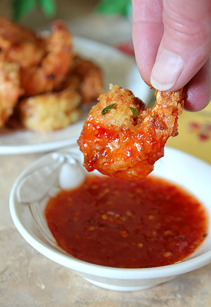 Crispy Coconut Shrimp with Curry Dipped into Sweet Chili Sauce