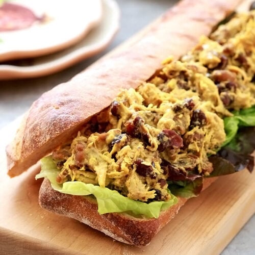 Curry Chicken Salad with Dried Cranberries and Walnuts on a Cutting Board