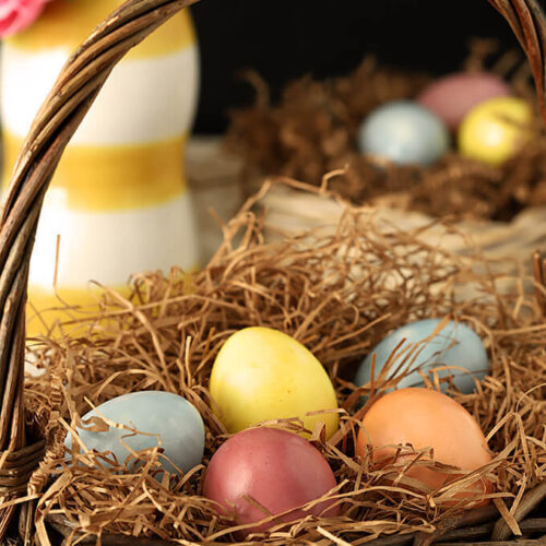 Decorated Easter Eggs with Organic Vegetables and Spices in an Easter Basket