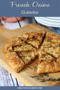 French Onion Galette Sliced, on a Bread Board