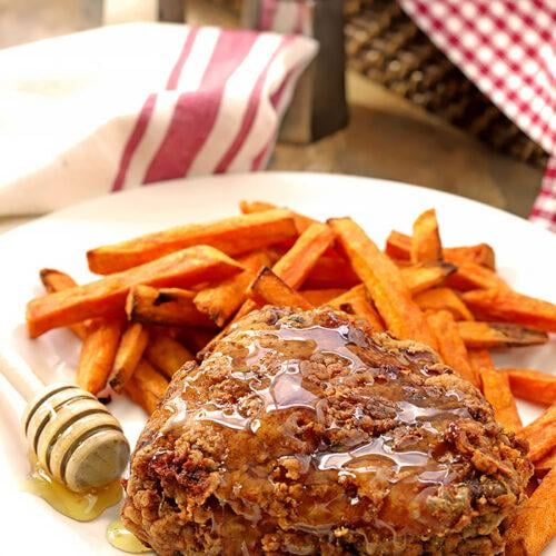 Buttermilk Fried Chicken is pan-fried and served with honey.