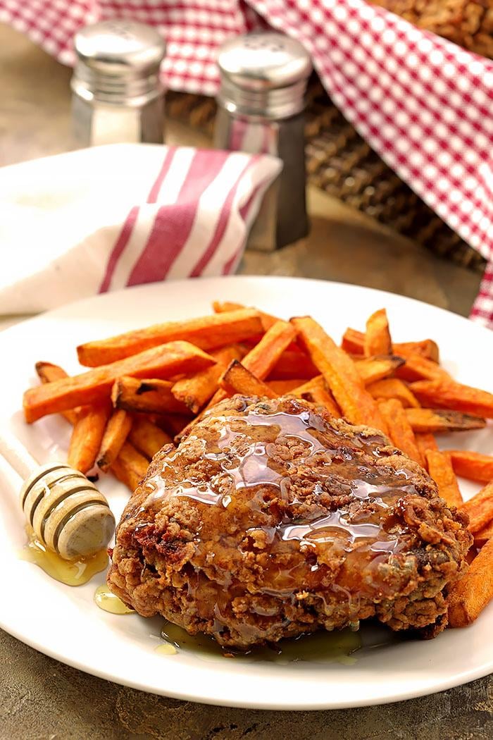 Buttermilk Fried Chicken is pan-fried and served with honey.