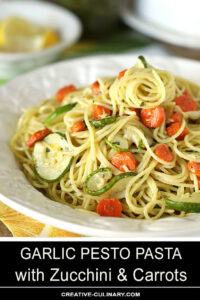 Garlic Pesto Pasta with Carrots & Zucchini Served on a White Plate