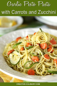 Garlic Pesto Pasta with Carrots & Zucchini Served on a White Plate