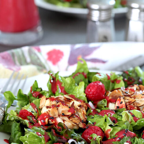 Goat Cheese and Raspberry Salad on a White Plate with Raspberry Dressing