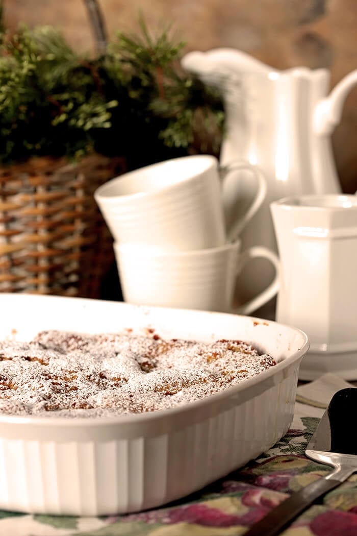 Gooey Butter Cake Overnight French Toast Served in a White Porcelain Baking Dish