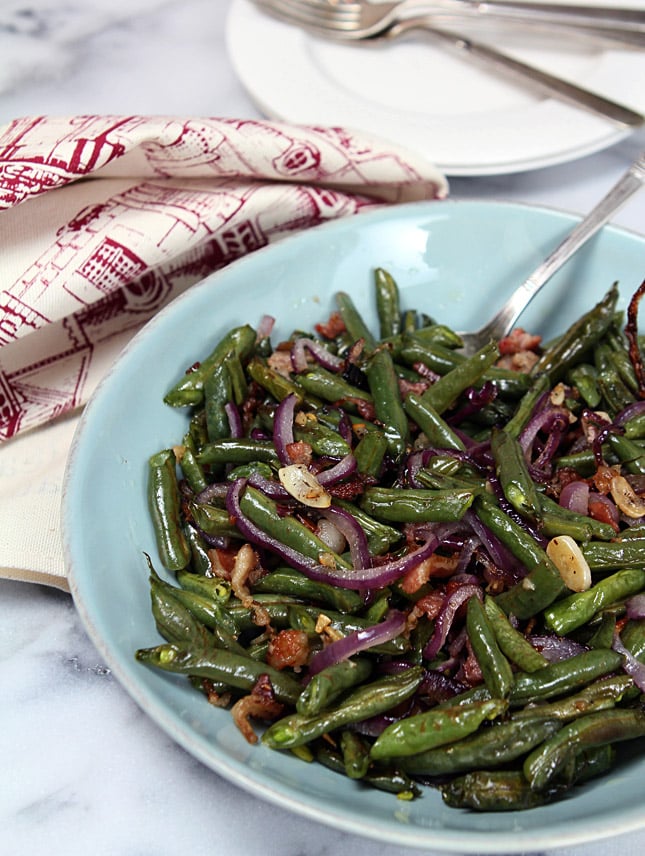 Roasted Green Beans with Red Onion Served in a Round Blue Ceramic Bowl