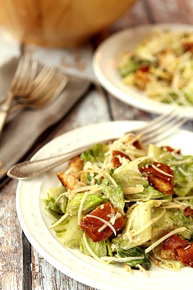 Grilled Caesar Salad with Homemade Croutons Served on a White Plate