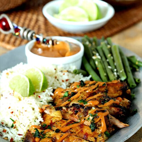 Grilled Chicken Thighs with Peanut Sauce on Plate with Green Beans and Rice