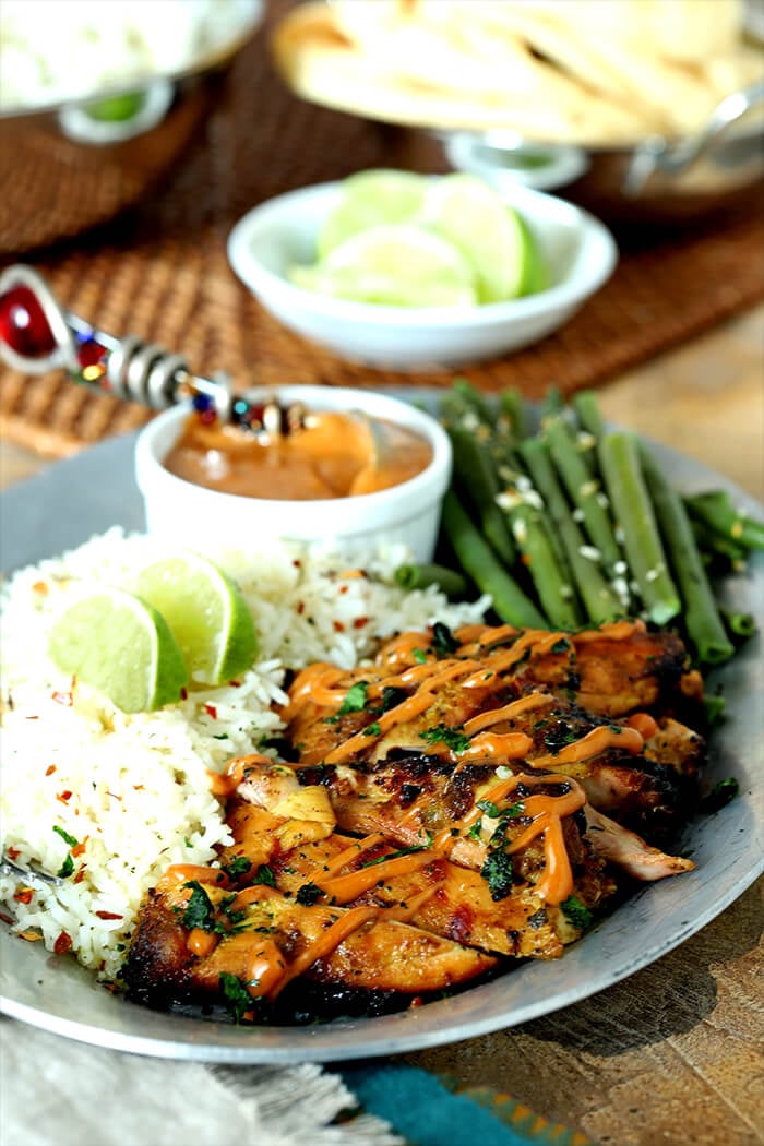 Grilled Chicken Thighs with Peanut Sauce on Plate with Green Beans and Rice