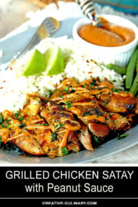 Grilled Chicken Thighs with Peanut Sauce on Plate with Rice Garnished with Lime Wedges