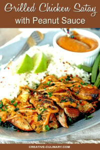 Grilled Chicken Thighs with Peanut Sauce on Plate with Rice Garnished with Lime Wedges