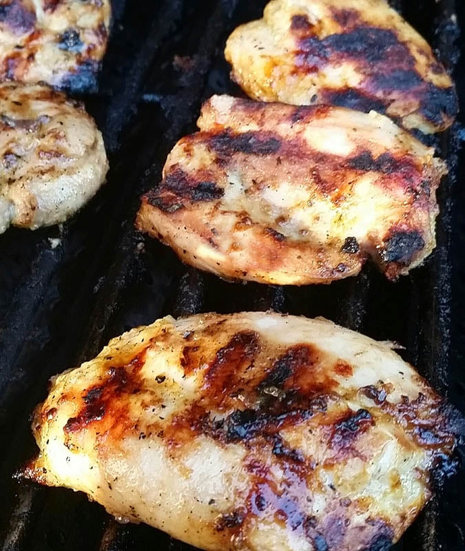 Limoncello and Herb Chicken Thighs Cooking on Outside Grill.