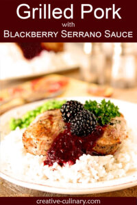 Grilled Pork with Blackberry Serrano Sauce Served with Rice and Garnished with Parsley.