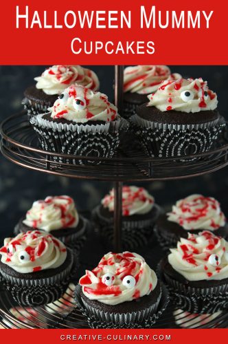 Multi layer cake stand with chocolate Halloween Mummy Cupcakes.