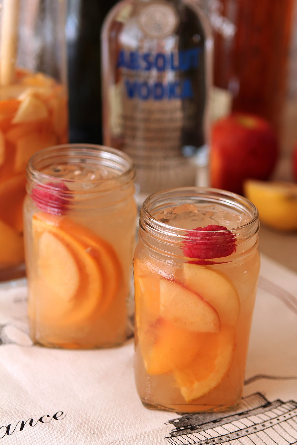 Two glasses of Hard Apple Cider Sangria served in mason jars.