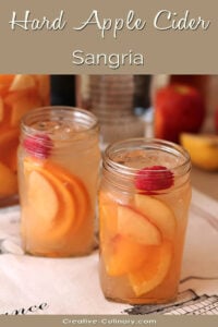 Hard Apple Cider Sangria with Peaches and Raspberries