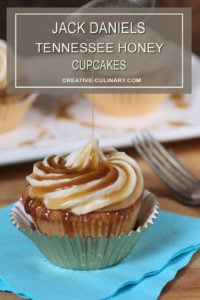 Closeup of Jack Daniels Honey Whiskey Cupcakes with a Boozy Drizzle from a Spoon