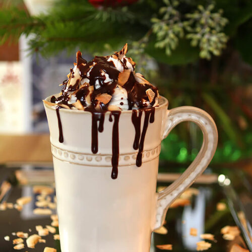 Hot Chocoate with Rum, Coconut, and Chocolate Sauce in a Cream Colored Mug