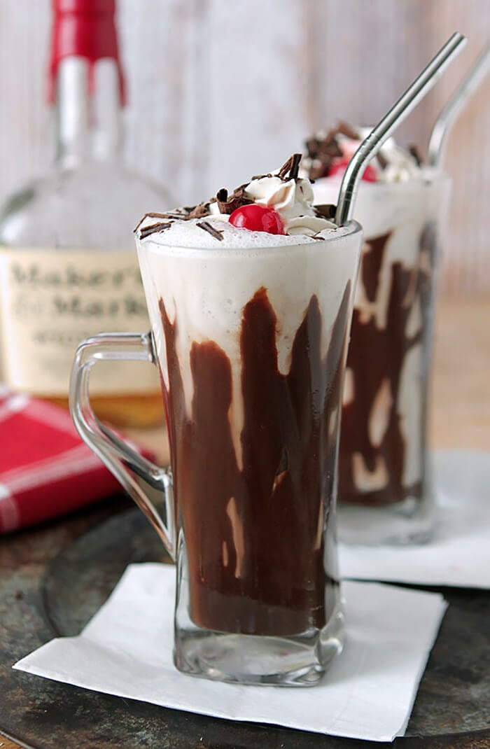 Bourbon and Hot Fudge Milkshake Served in a Tall Old Fashioned Soda Glass with a Maraschino Cherry on Top