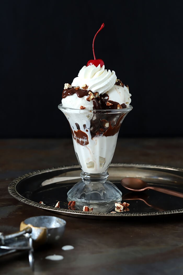 Gold Brick Chocolate Fudge Sundae Sauce Layered with Vanilla Ice Cream, Whipped Cream, Toasted Pecans and a Maraschino Cherry