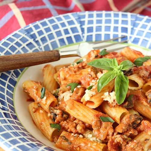 Roasted Tomato and Italian Sausage Pasta with Cream in Blue and White Bowl