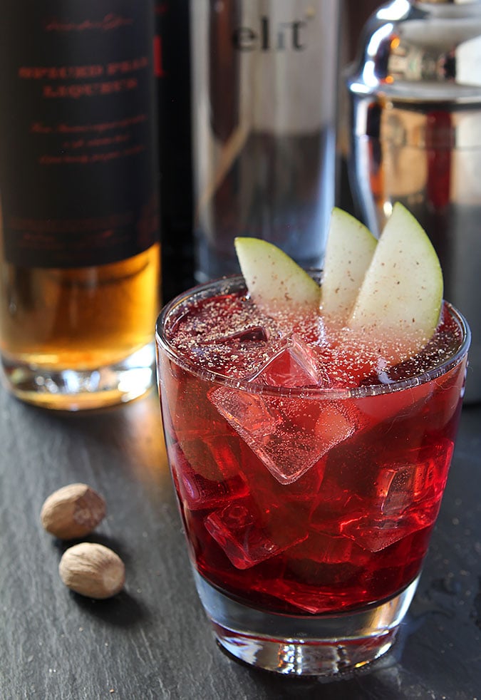 Vodka, Red Wine and Spiced Pear Liqueur Cocktail Garnished with Pear Slices and Nutmeg