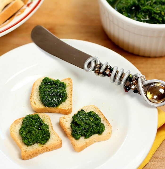 Kale Pesto with Crackers Served on a White Plate