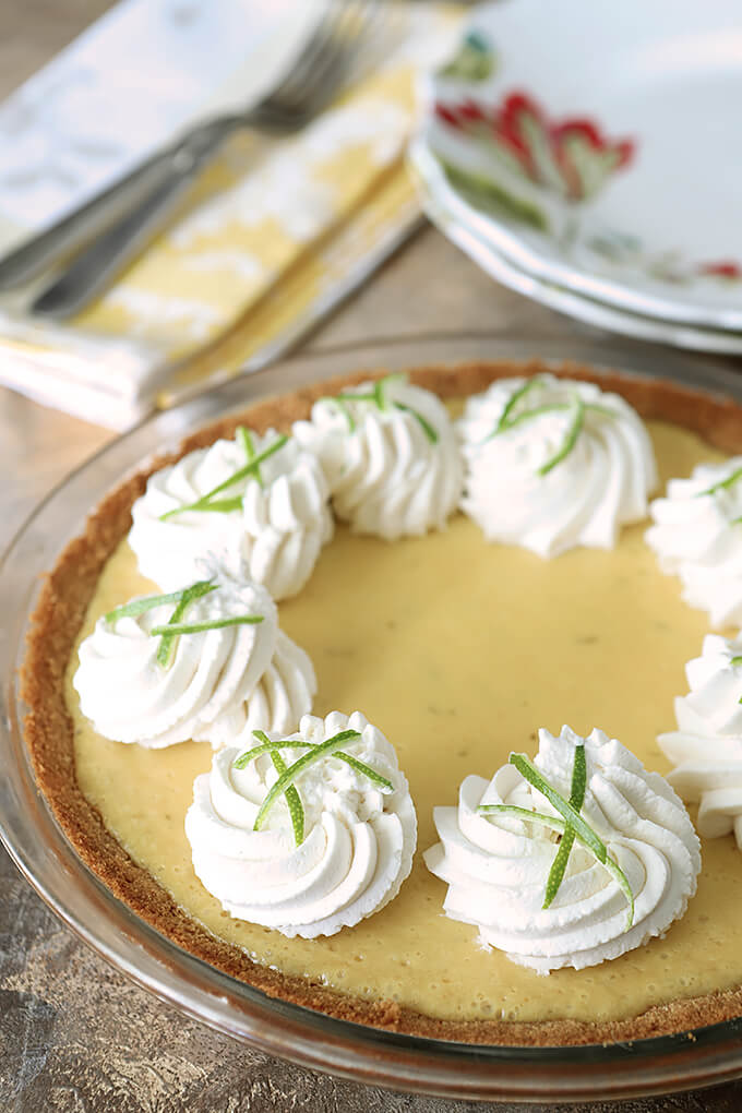 Key Lime Pie with Whipped Cream and Lime Zest in a Table Setting