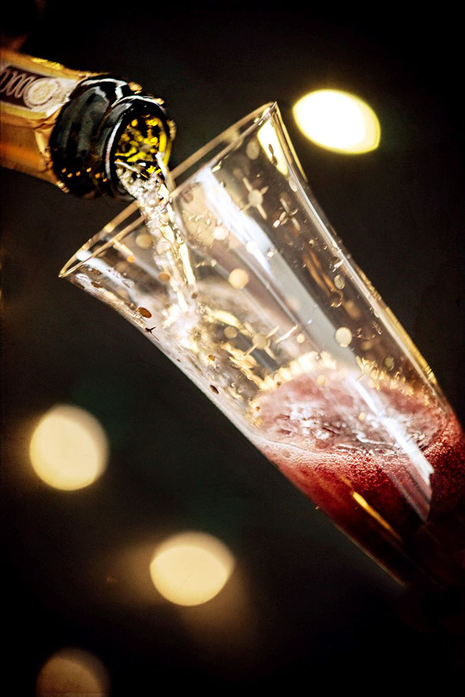 Kir Royale Champagne Cocktail Showing Champagne Pouring into Glass with Creme de Cassis