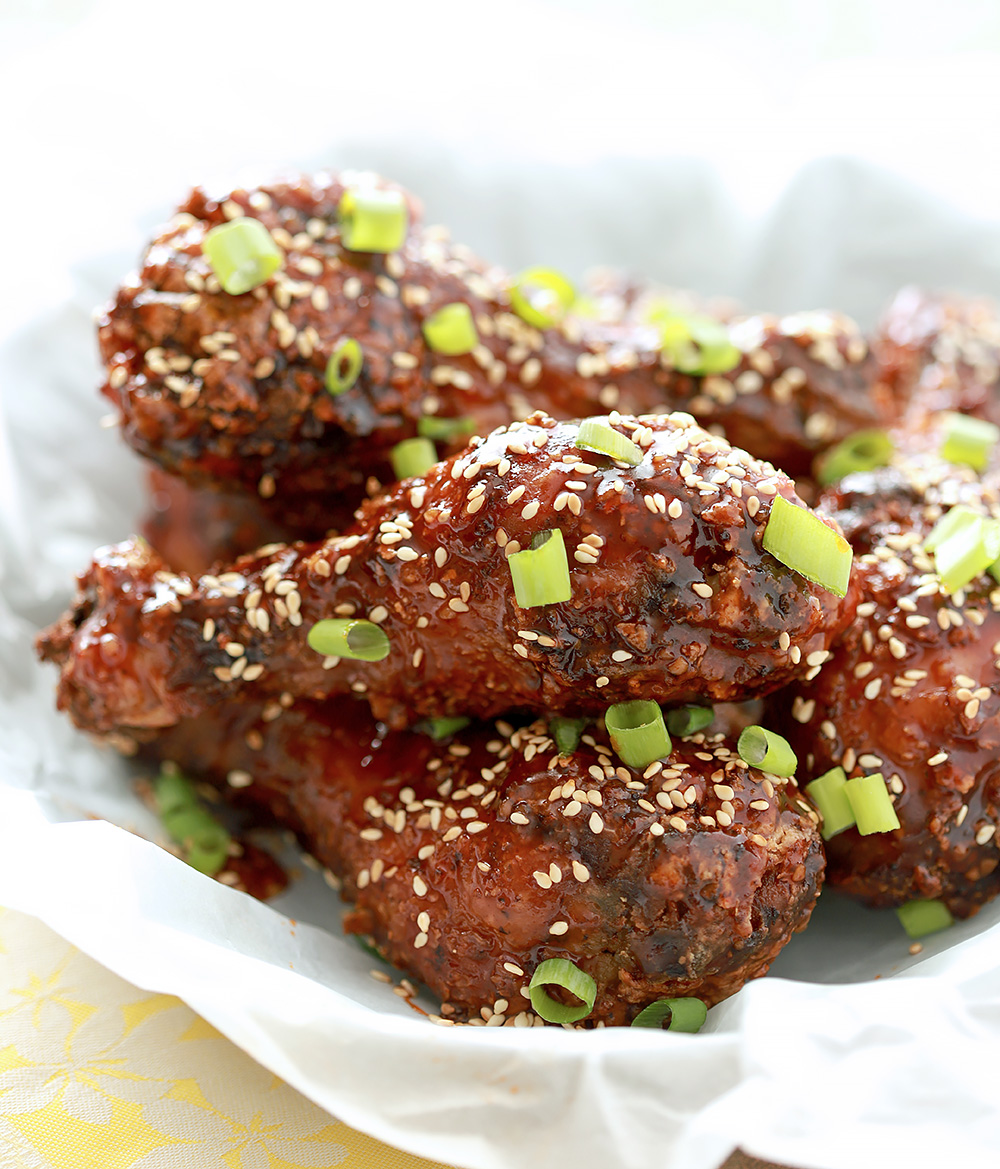 Korean Fried Chicken Piled on a Plate and Garnished with Scallions.