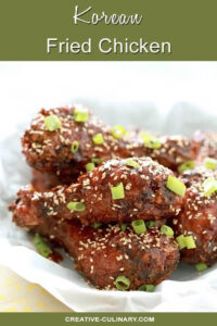 Korean Fried Chicken with Gochujang Sauce and Garnished with Sesame Seeds and Green Onion