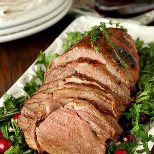 Honey Roasted Lamb with Honey and Thyme on White Serving Plate with Garnish