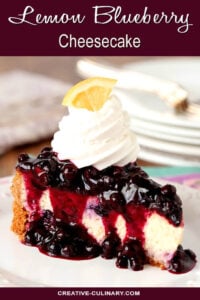 Single Slice of Lemon Blueberry Cheescake with a Blueberry Topping Served on a White Plate with Whipped Cream Topping