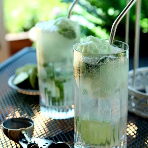 Lime Sherbet Mojito Float is a light specialty cocktail for summer served in a tall glass.