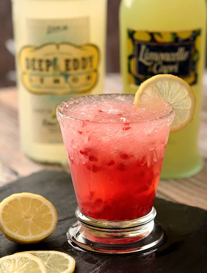 Limoncello and Raspberry Sparkling Slushy Cocktail on Slate Server with Lemon Wheel Garnish