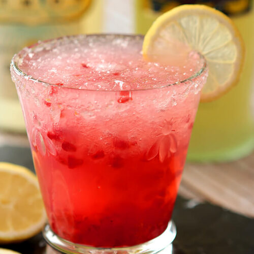 Limoncello and Raspberry Sparkling Slushy Cocktail Closeup of Glass Garnished with Lemon Wheel